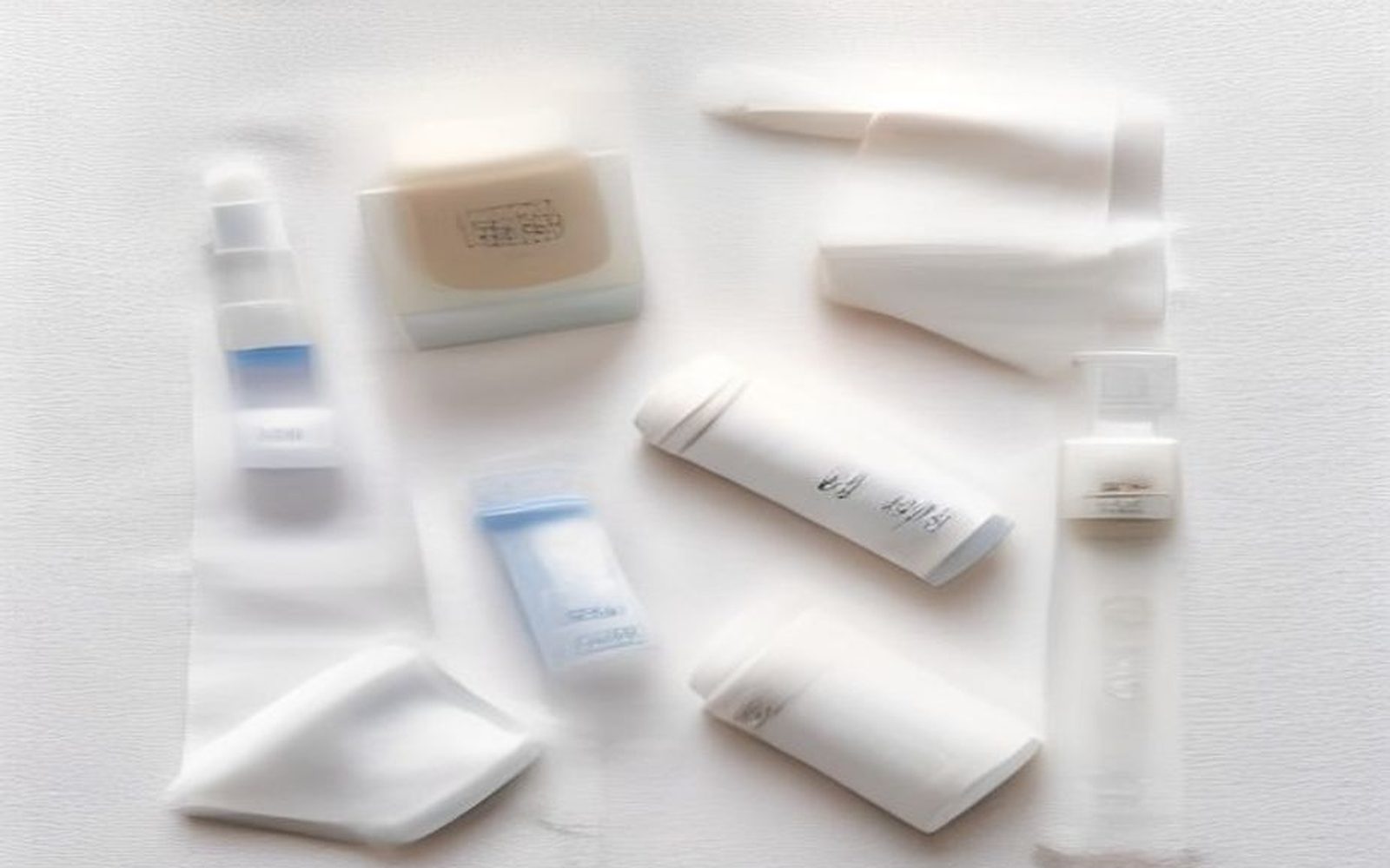 Unbranded Korean skincare bottles on linen